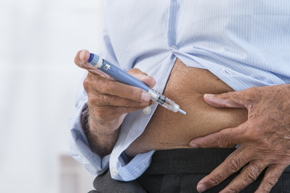 Image of man using pen injector